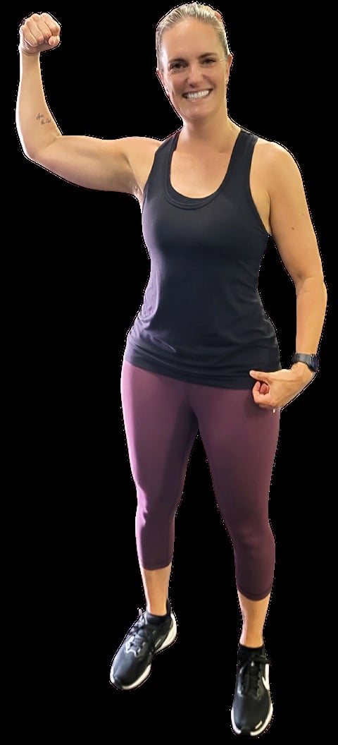 Fit woman in athletic wear flexing her bicep with a confident smile