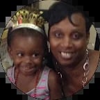 Woman and young child smiling at camera, child wearing gold tiara crown